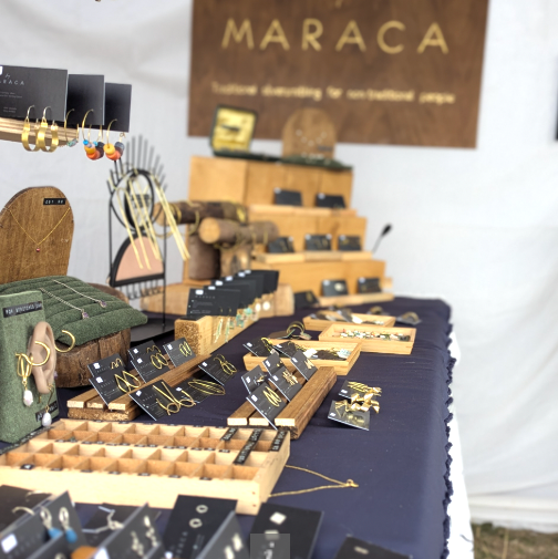 Display of Maraca products with a 'by MARACA' sign in the background.